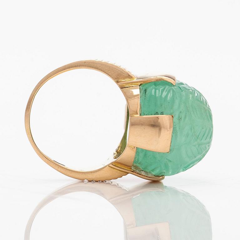 An 18K gold ring with a cabochon-cut emerald, import-stamped A. Tillander.