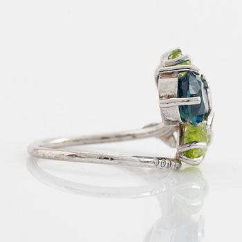 Blue topaz, carved peridot leaf, brilliant cut diamond ring.