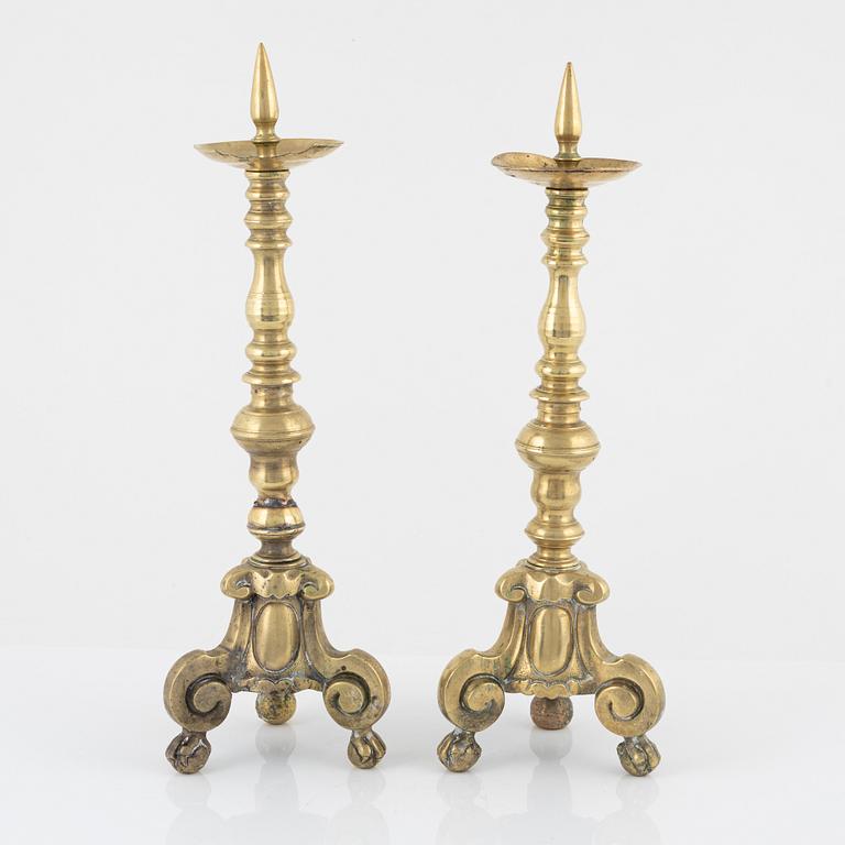 A pair of brass candle sticks, around 1700.