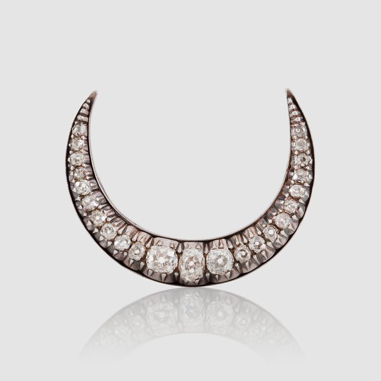 A Victorian old-cut diamond brooch in the shape of a half-moon. Total carat weight circa 2.50 cts.