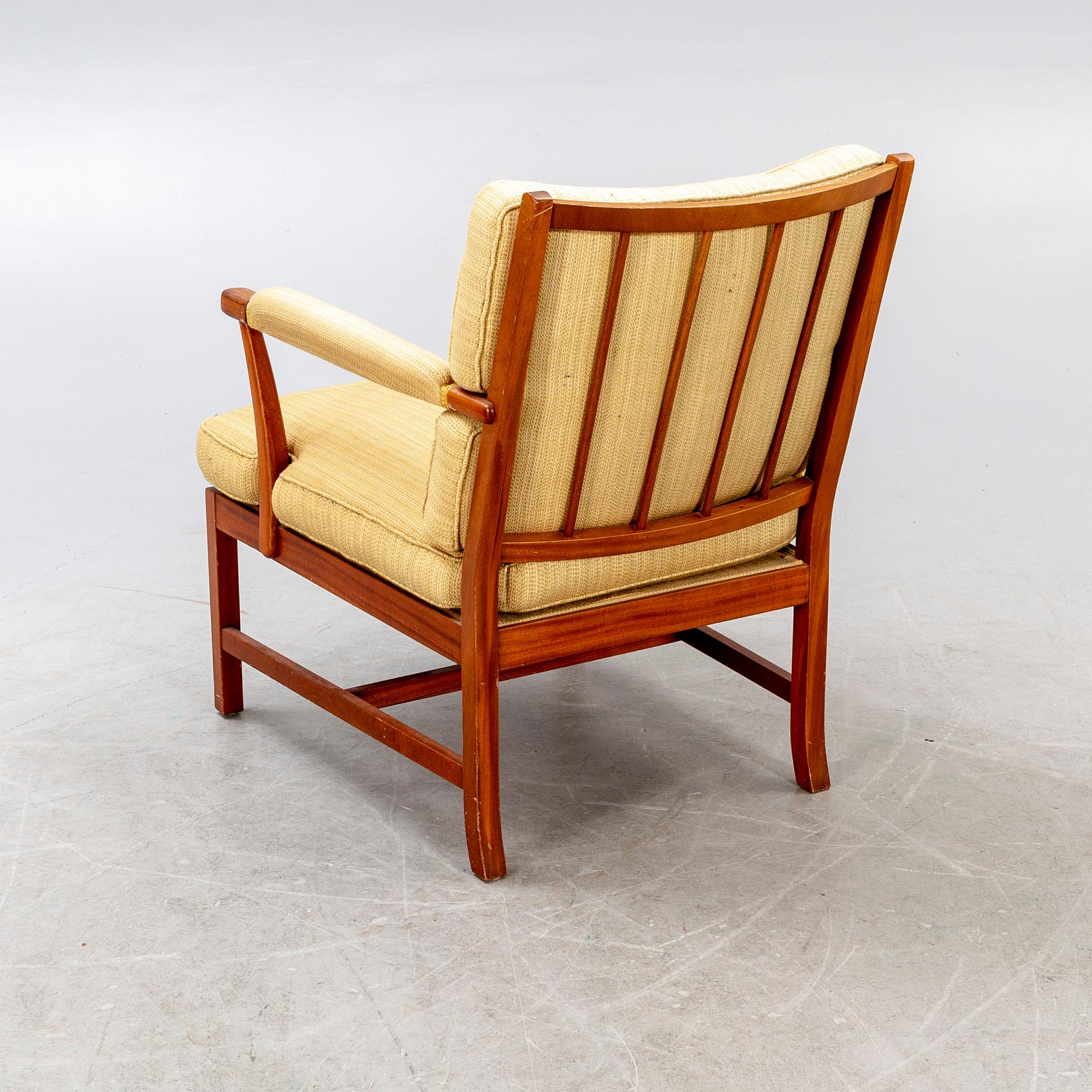 A Josef Frank walnut armchair Firma Svenskt Tenn model nr 667.