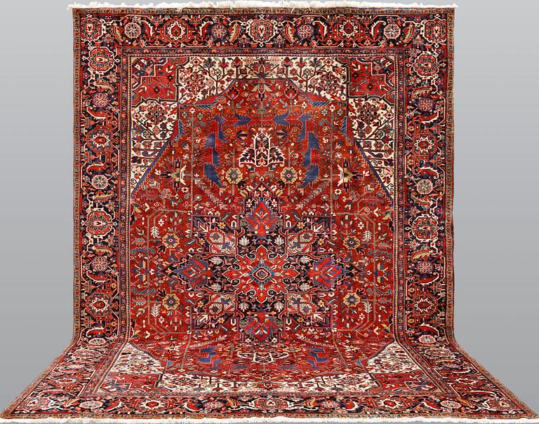 A  semi-antique Heris carpet, approx. 396 x 286 cm.