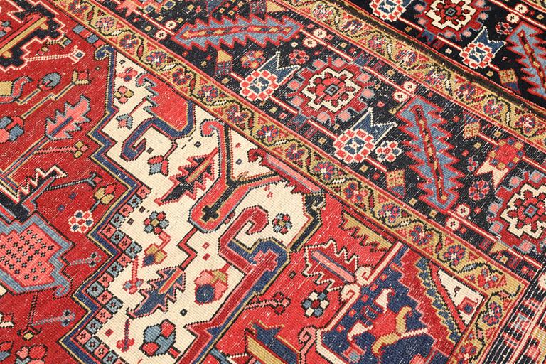 A semi-antique Heris carpet, approx. 343 x 260 cm.
