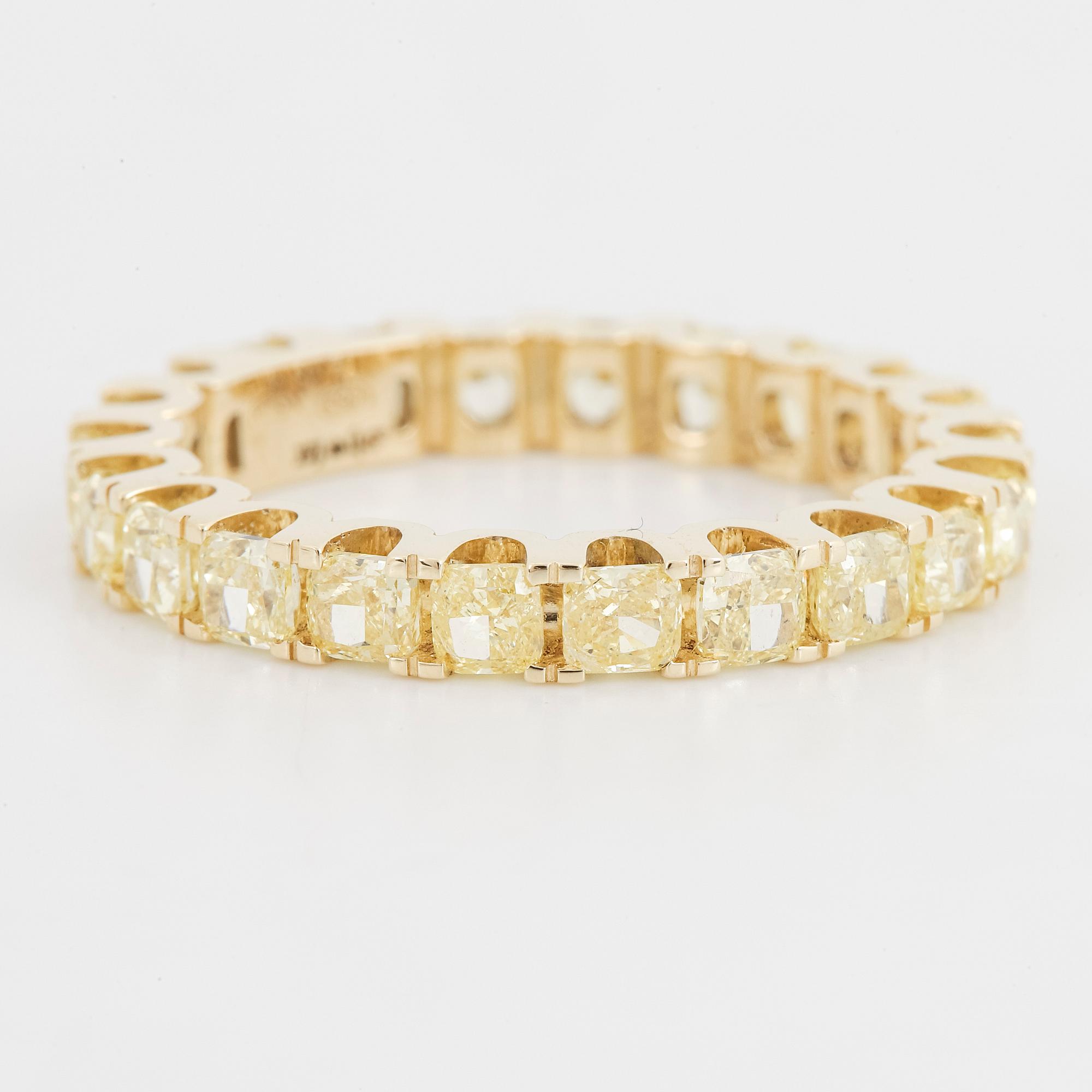 Yellow cushion shaped diamond ring.