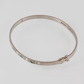 ARMRING, 18k vitguld med 5 briljantslipade diamanter och 4 smaragder, Sten Gramen, Göteborg, 1965. Vikt 13,3 gram.