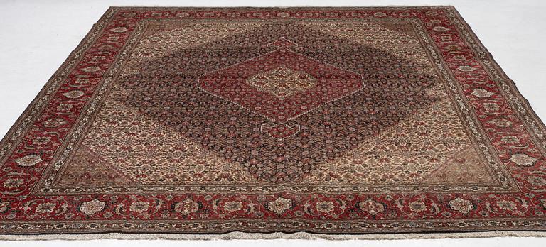 A signed Tabriz carpet, c. 385 x 300 cm.
