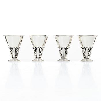 Evald Nielsen, four sterling silver beakers/cups on a foot, Denmark 20th century.