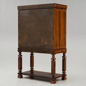 A Gösta Thorell cabinet on stand, Stockholm 1929, executed by Georg Ryman.