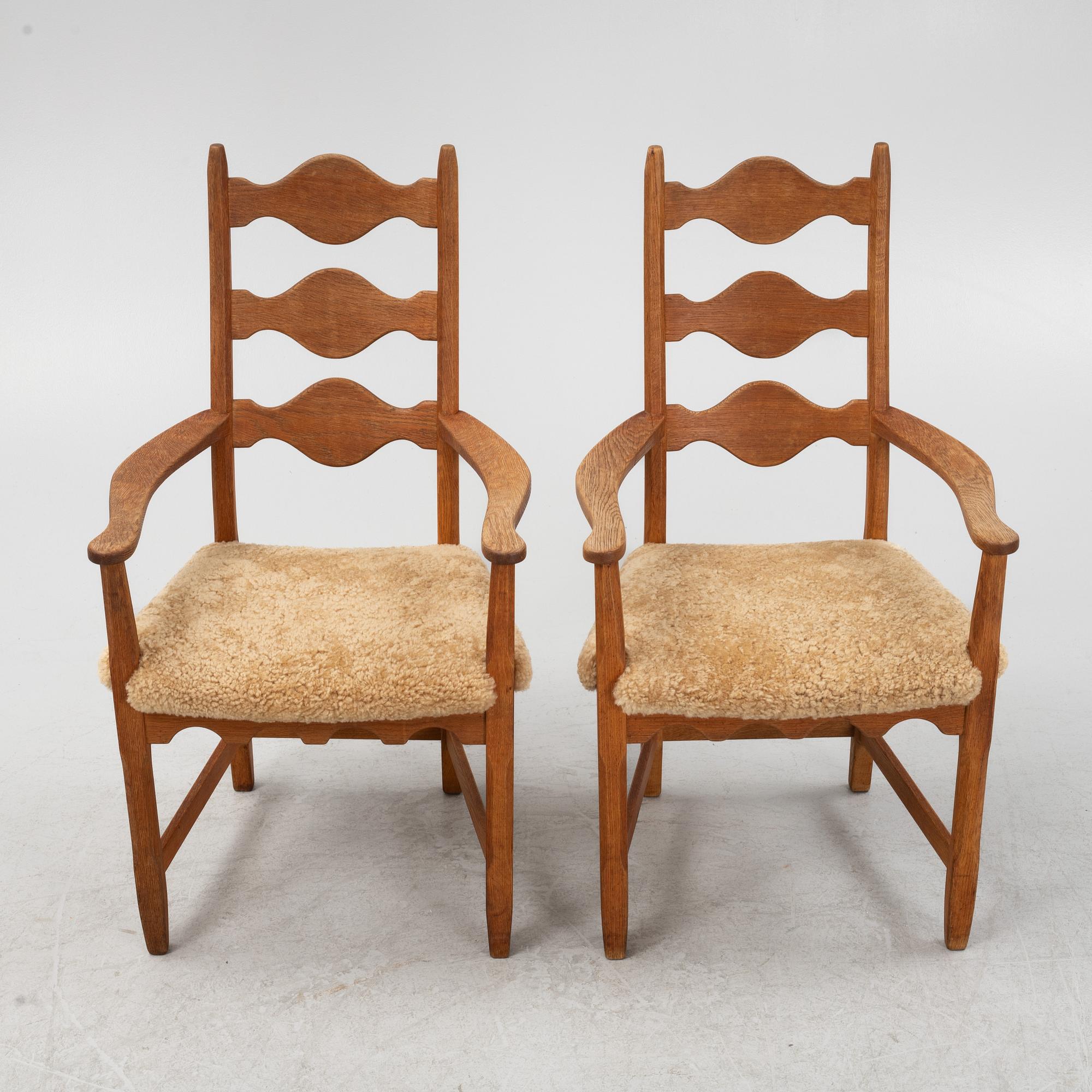 Henning Kjærnulf, a pair of oak 'Razorblade' armchairs with new sheepskin upholstery, from EGK, Demark, 1960s.