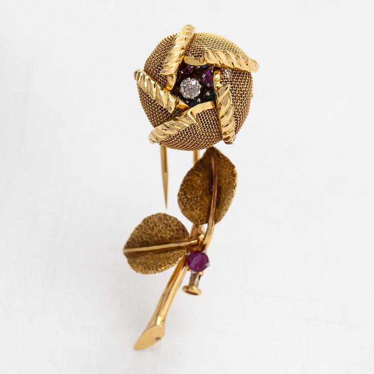 An 18K gold "en tremblant" flower brooch set with a diamond, rubies, sapphires, and emeralds. French hallmarks.