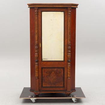 A corner cabinet, circa 1900.