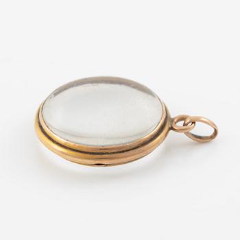 Medaljong, guld och glas.