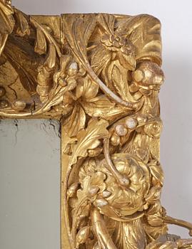 A presumably Dutch Louis XIV carved giltwood frame with mirror glass, in the style of Jean Le Pautre, late 17th century.