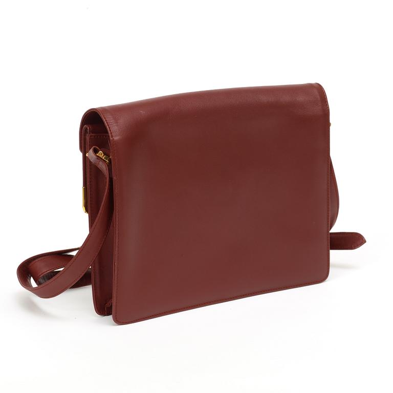 A wine red leather shoulder bag and wallet by Cartier.