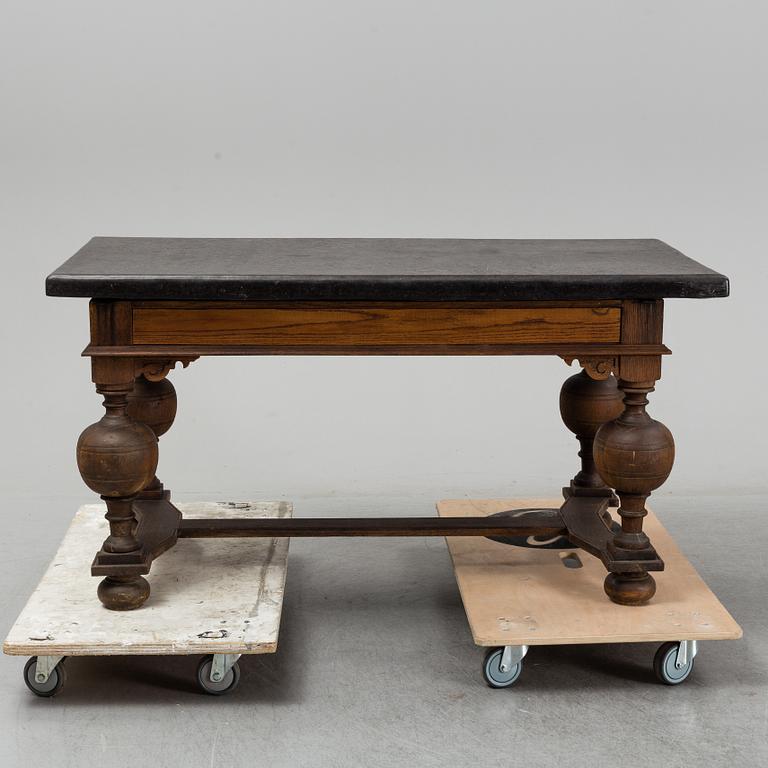 A 19th Century Baroque style table with a stone top.