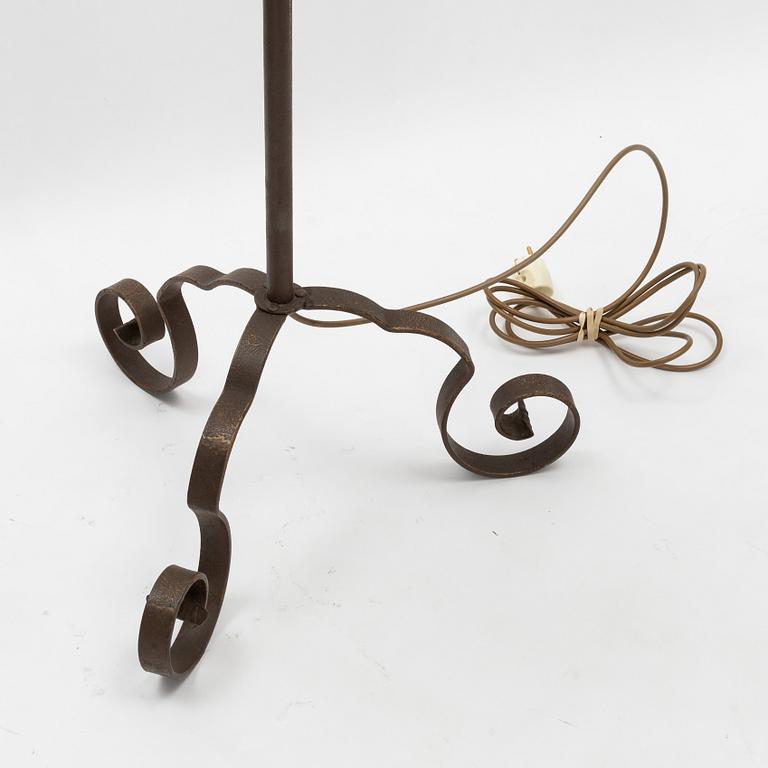An iron floor lamp, early 20th Century.