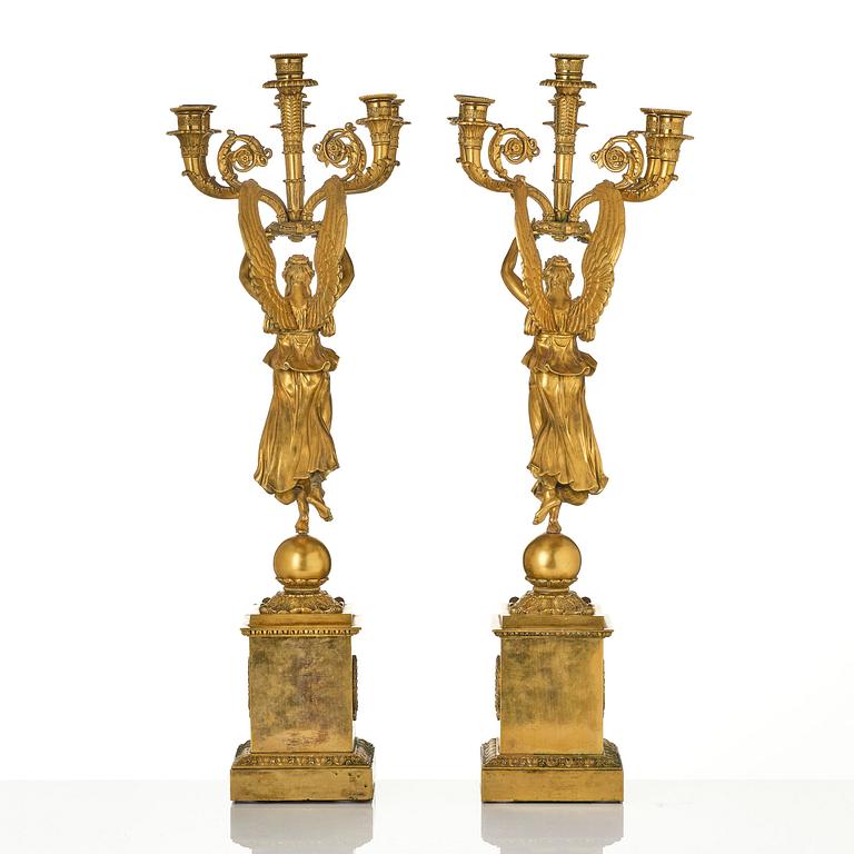 A pair of six-branch gilt bronze Empire candelabra, Paris, early 19th century.