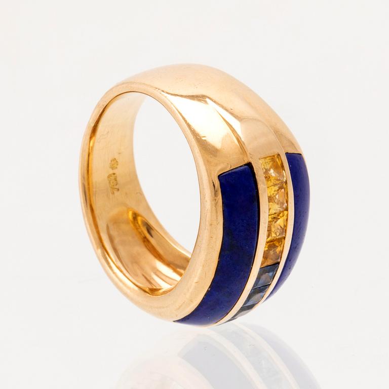 An 18K gold ring set with princess-cut blue and yellow, likely, sapphires as well as Lapis Lazuli.