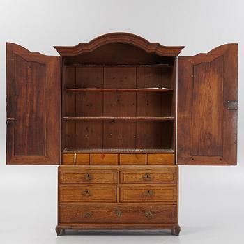 An oak rococo cabinet, mid 18th Century.