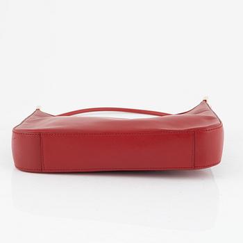 Gucci, a red leather handbag.
