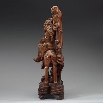 A large wooden sculpture group of Guandi on horseback and an attendant, Qing dynasty (1644-1912).