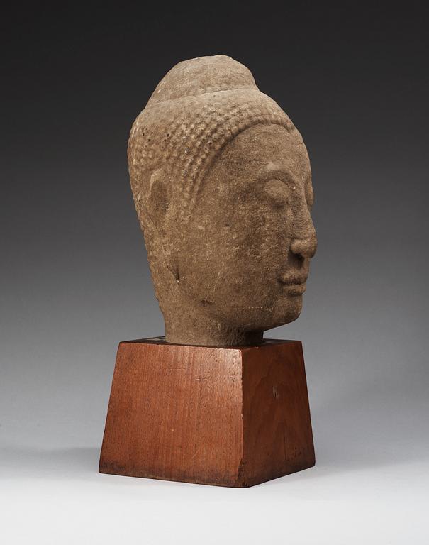 A large Lopbury type (later style) sandstone head of a Buddha, 17/18th Century.