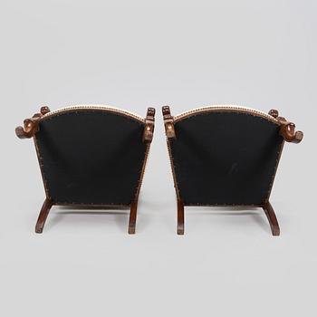 A pair of French open-arm chairs, first half of the 19th century.