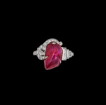 950. A carved untreated Burmese ruby 6.02 cts and diamond ring. Total carat weight of diamonds circa 0.30 ct.