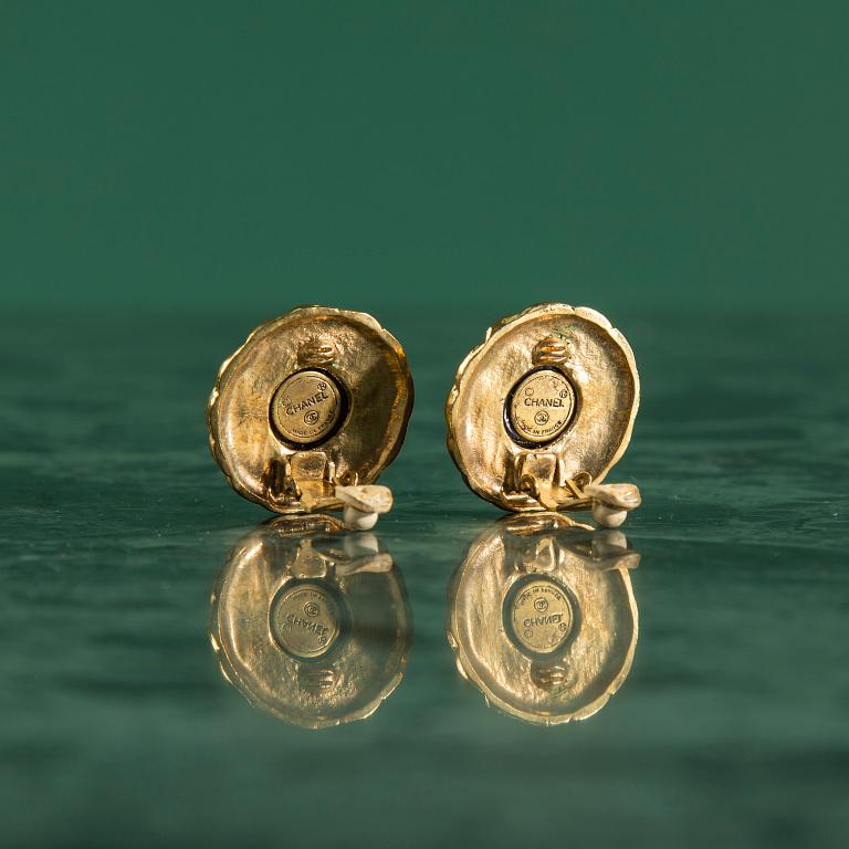 Earclips by Chanel.