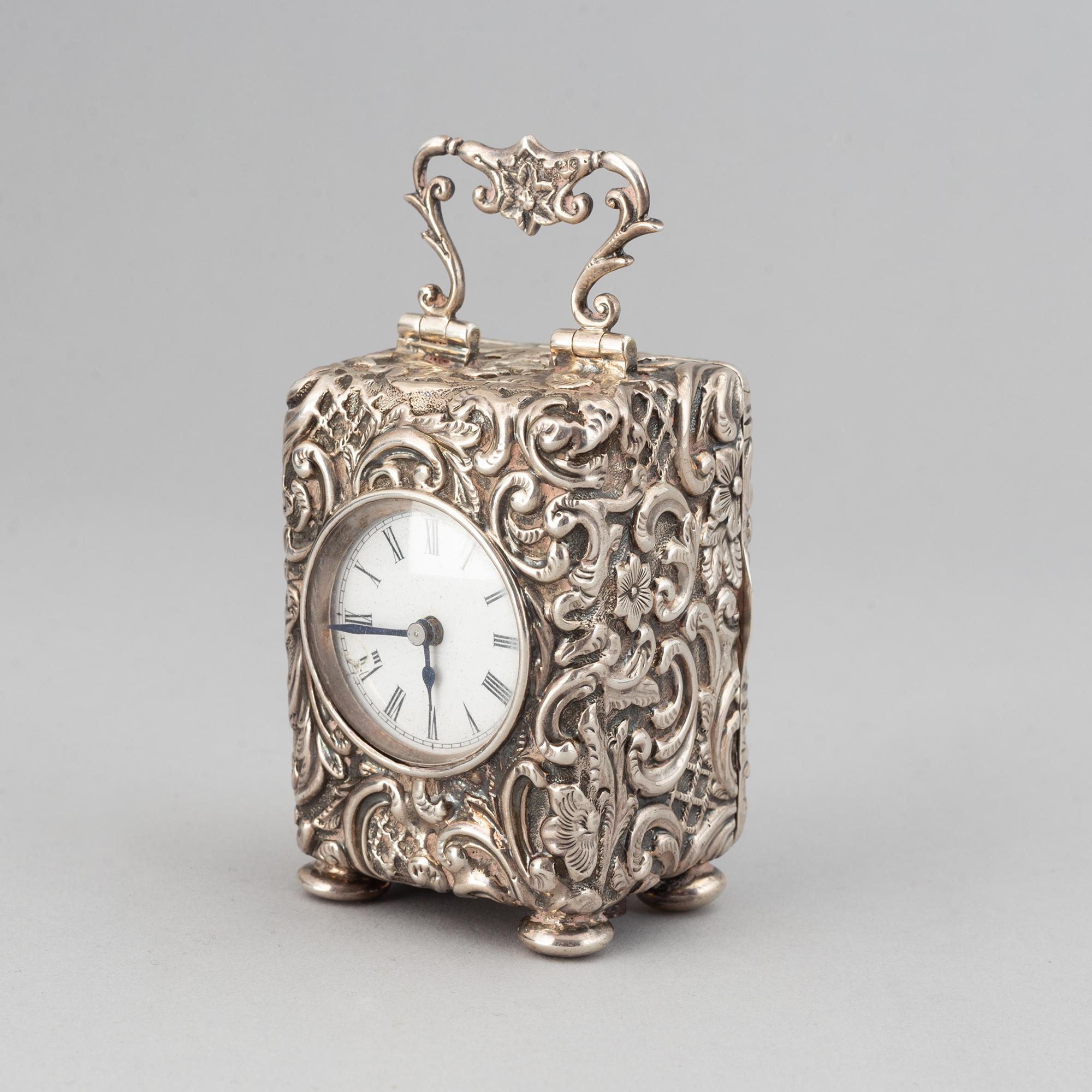 A rococo-style silver clock, mark of Henry Matthews, Chester 1903.