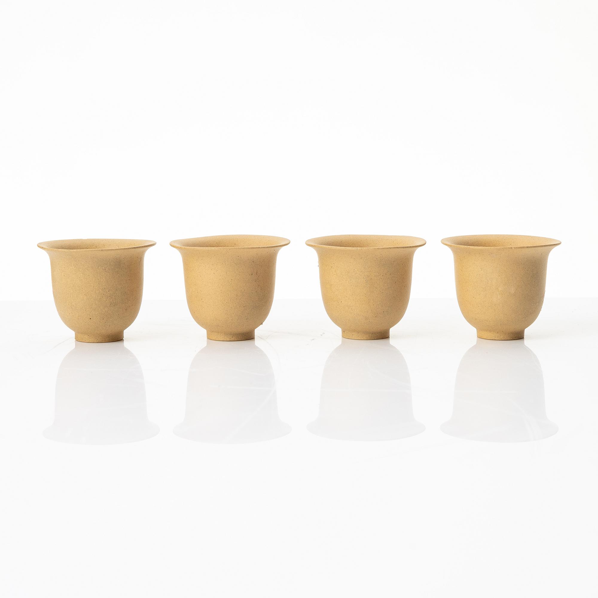 A set of a yellow yixing 'gongfu' teapot and four cups, China, 1980s.