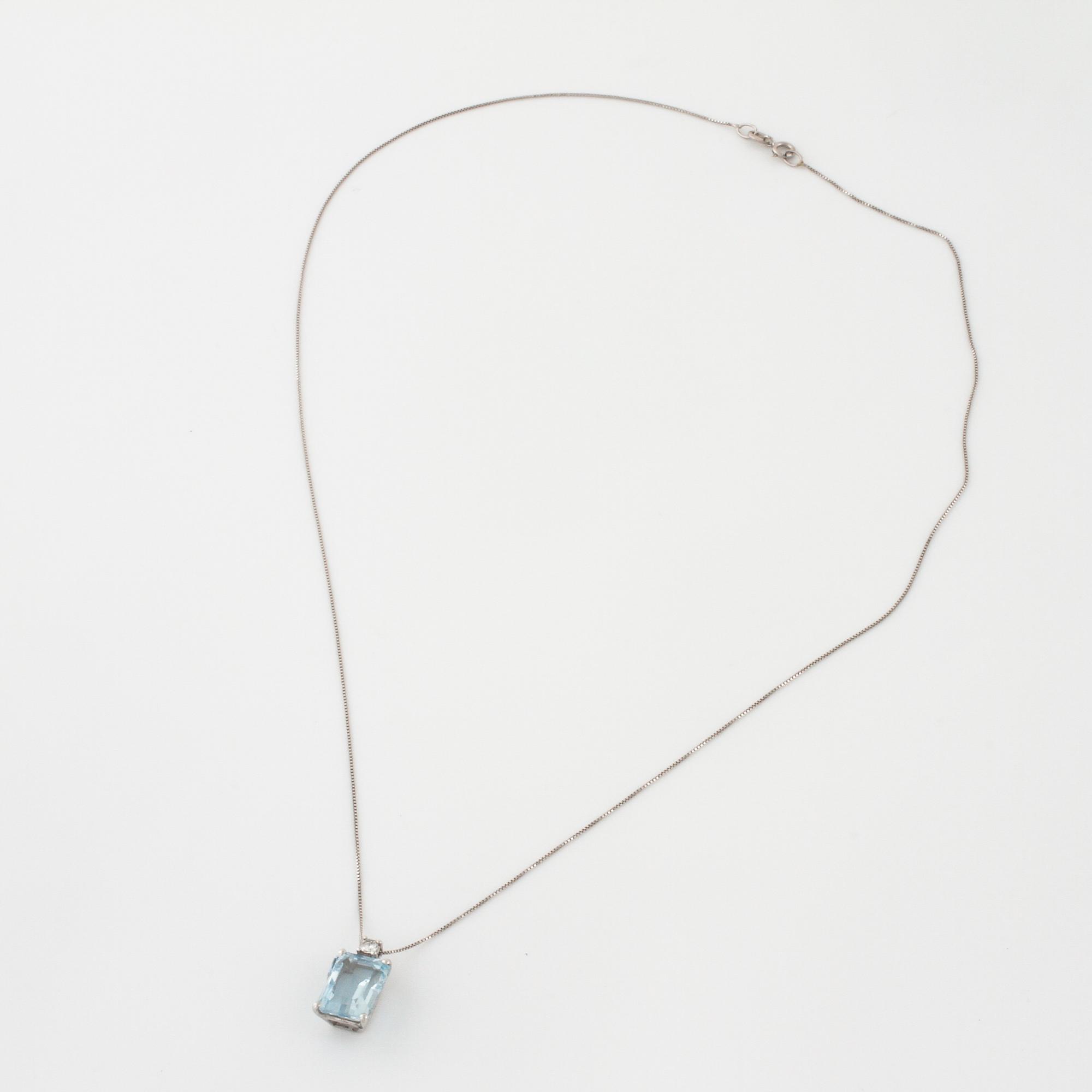 A aquamarine and briliant cut diamond pendant.