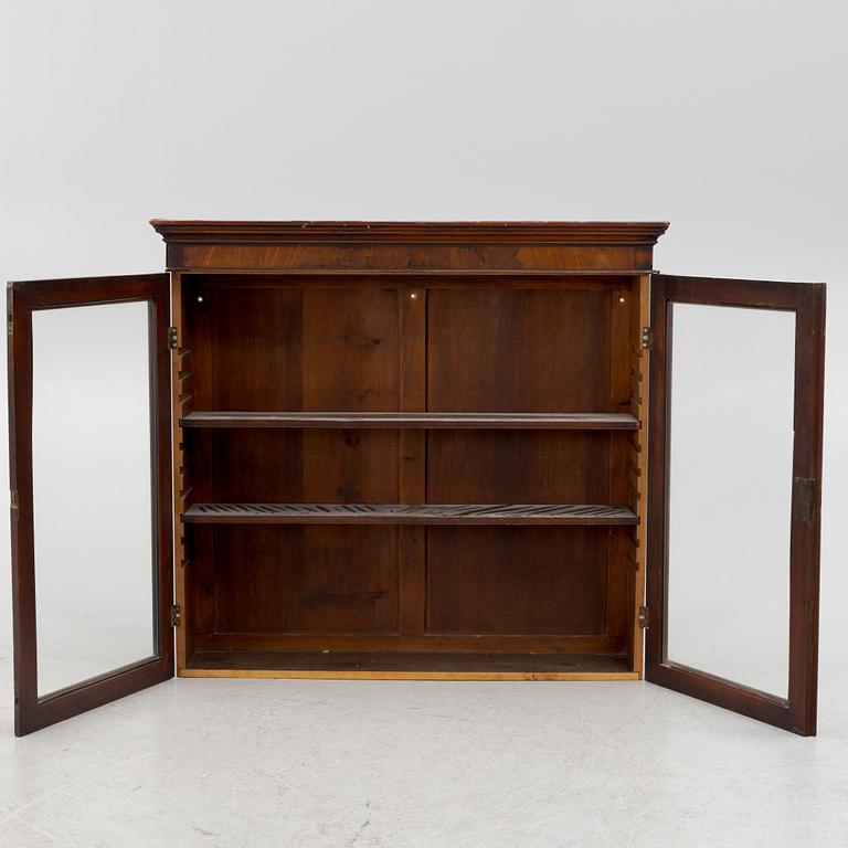 A mahogany veneered vitrine wal cabinet.