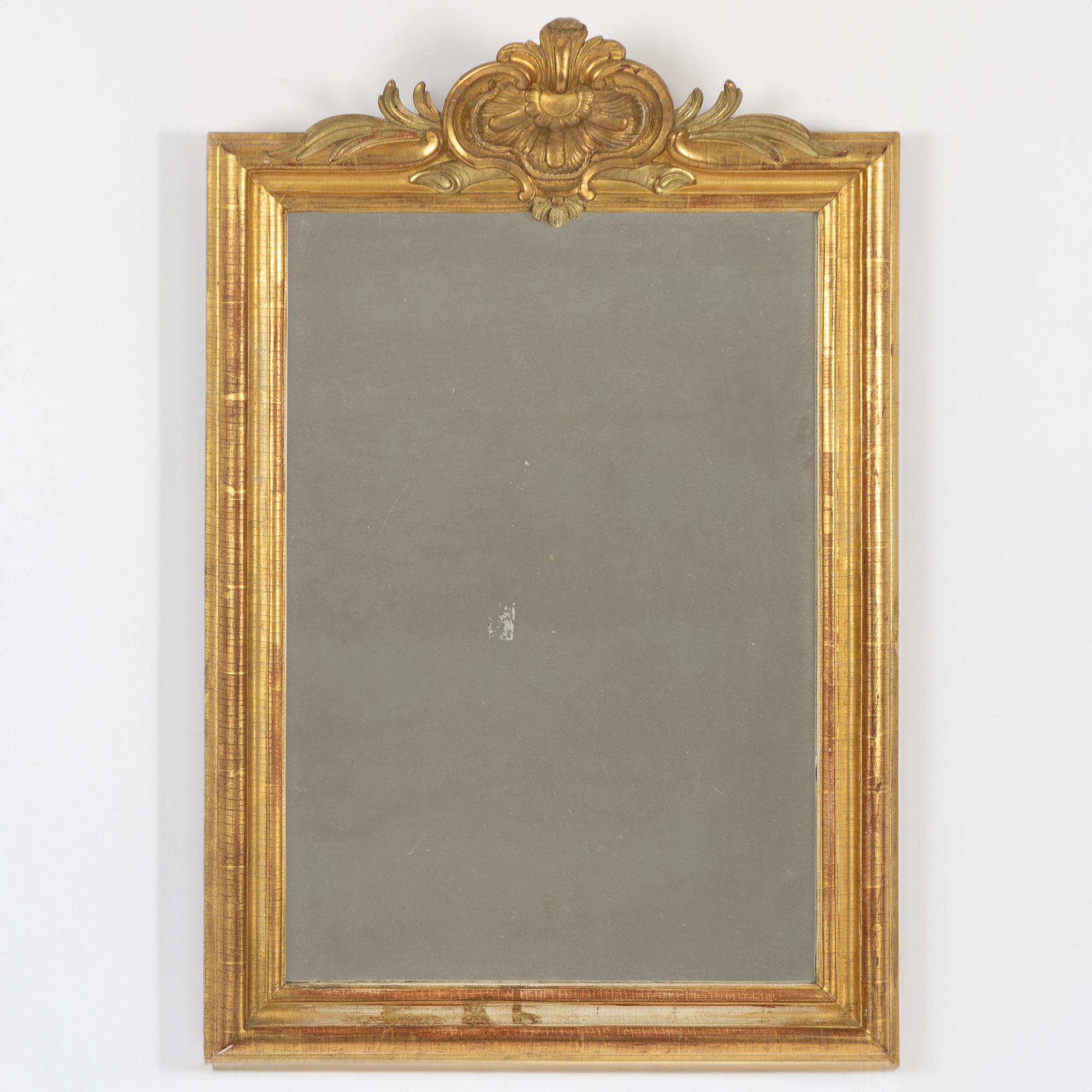 A Gustavian giltwood frame with mirror glass, Stockholm, late 18th century.
