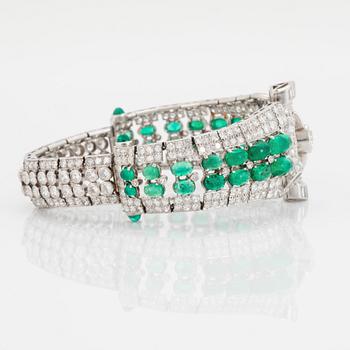 A platinum bracelet set with cabochon-cut emeralds and old-, eight- and baguette-cut diamonds.