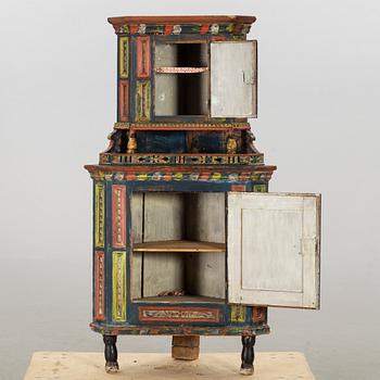 A SWEDISH CORNER CABINET, 1855.