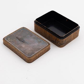 A Japanese woven bamboo box with metal inlaid shibuichi top early 20th century.