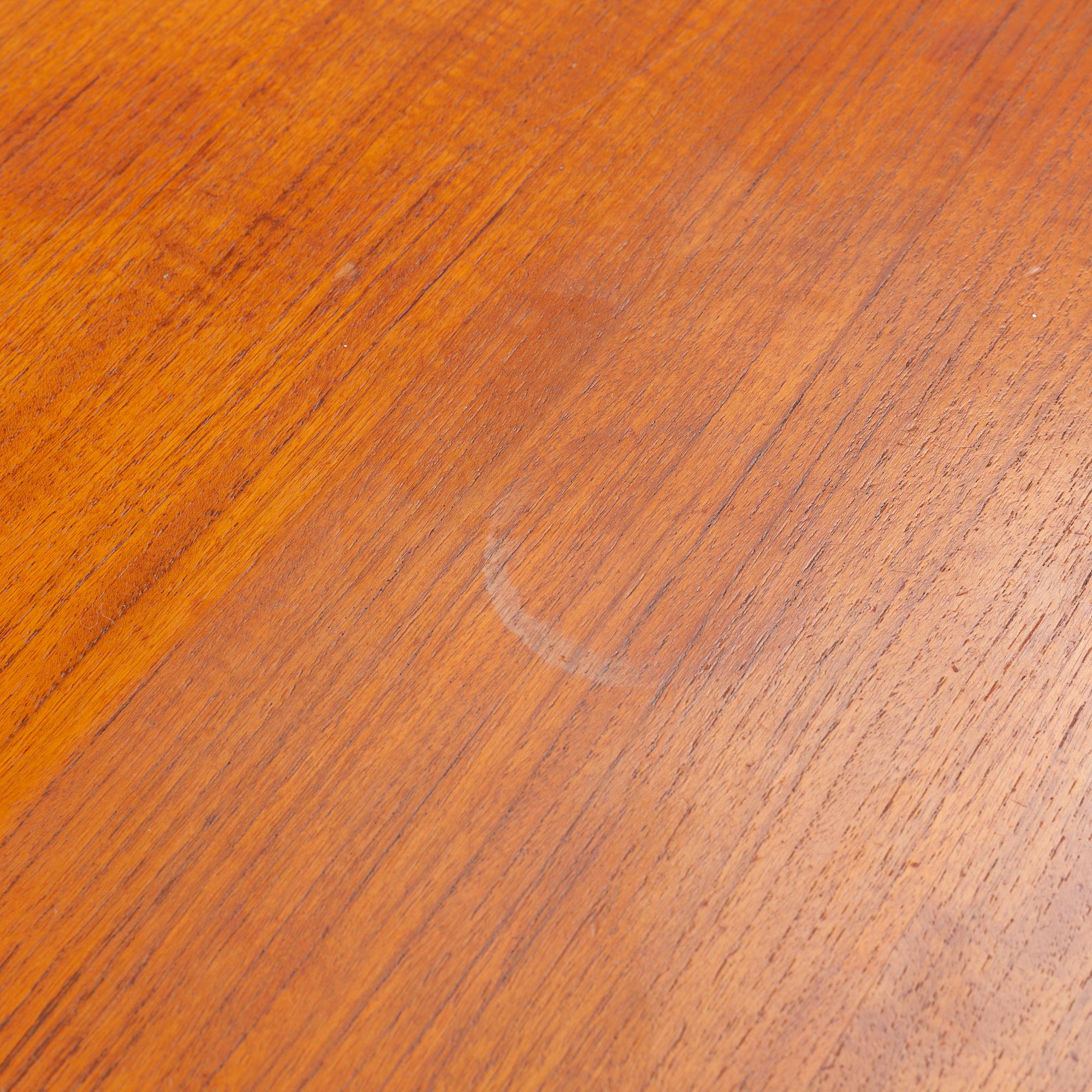 A teak veneer and stained beech dining table, mid 20th Century.
