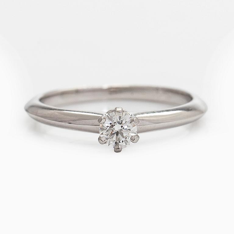 Tiffany & Co, a platinum solitaire ring with a brilliant-cut diamond.