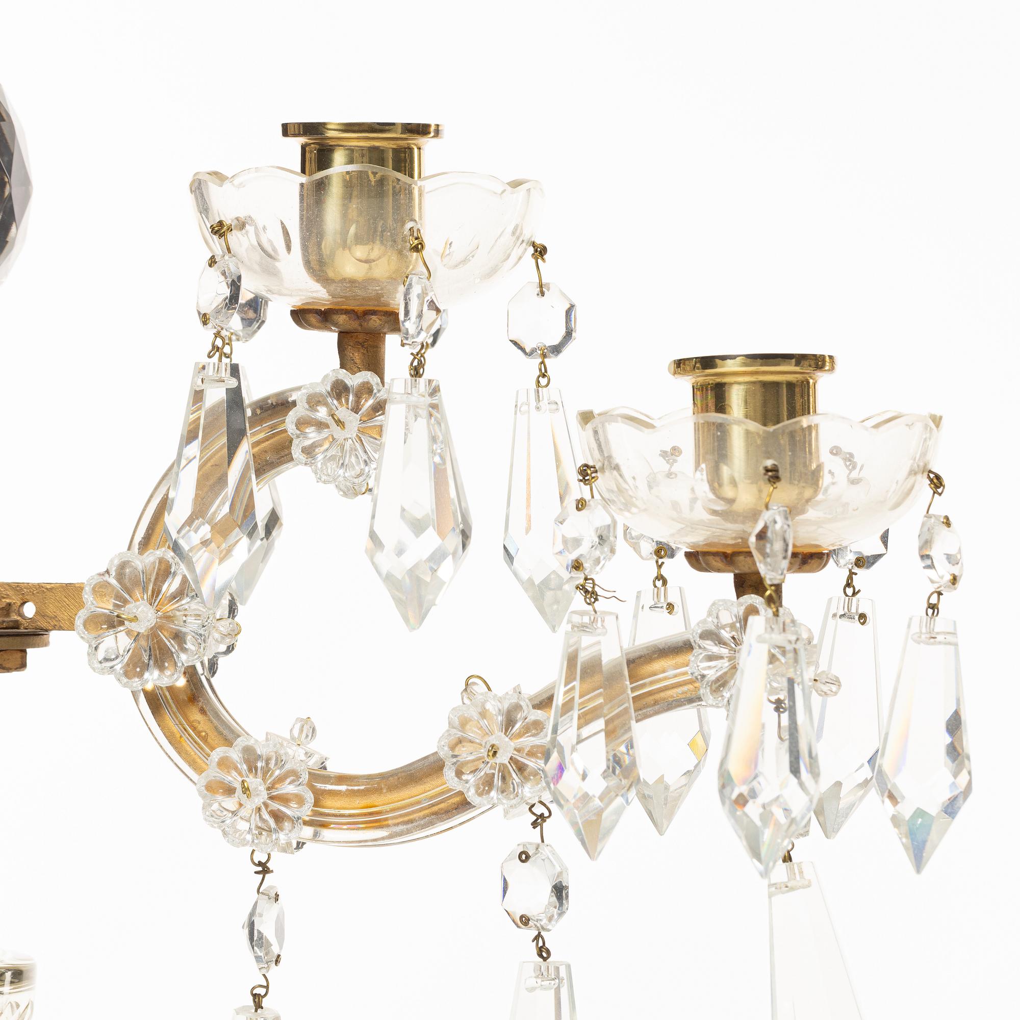 A pair of brass and glass canelabras, first half of the 20th century.