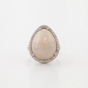A cabochon cut white opal and a brilliant cut diamond ring.