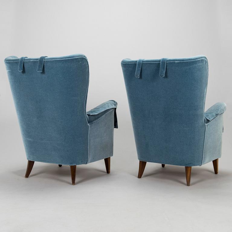 A pair of mid-20th century armchairs.