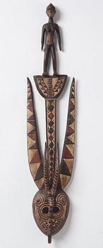A sculptue and two masks reportedly from The Ivory coast, from the second half of the 20:th century.