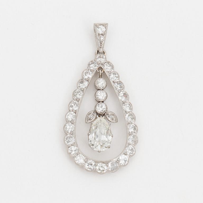 A pendant set with a pear cut diamond surrounded by old cut diamonds.