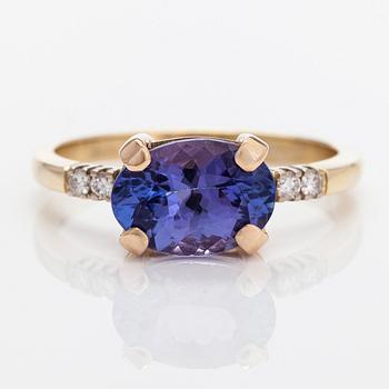 A 14K gold ring, with a tanzanite and diamonds totalling approximately 0.08 ct.