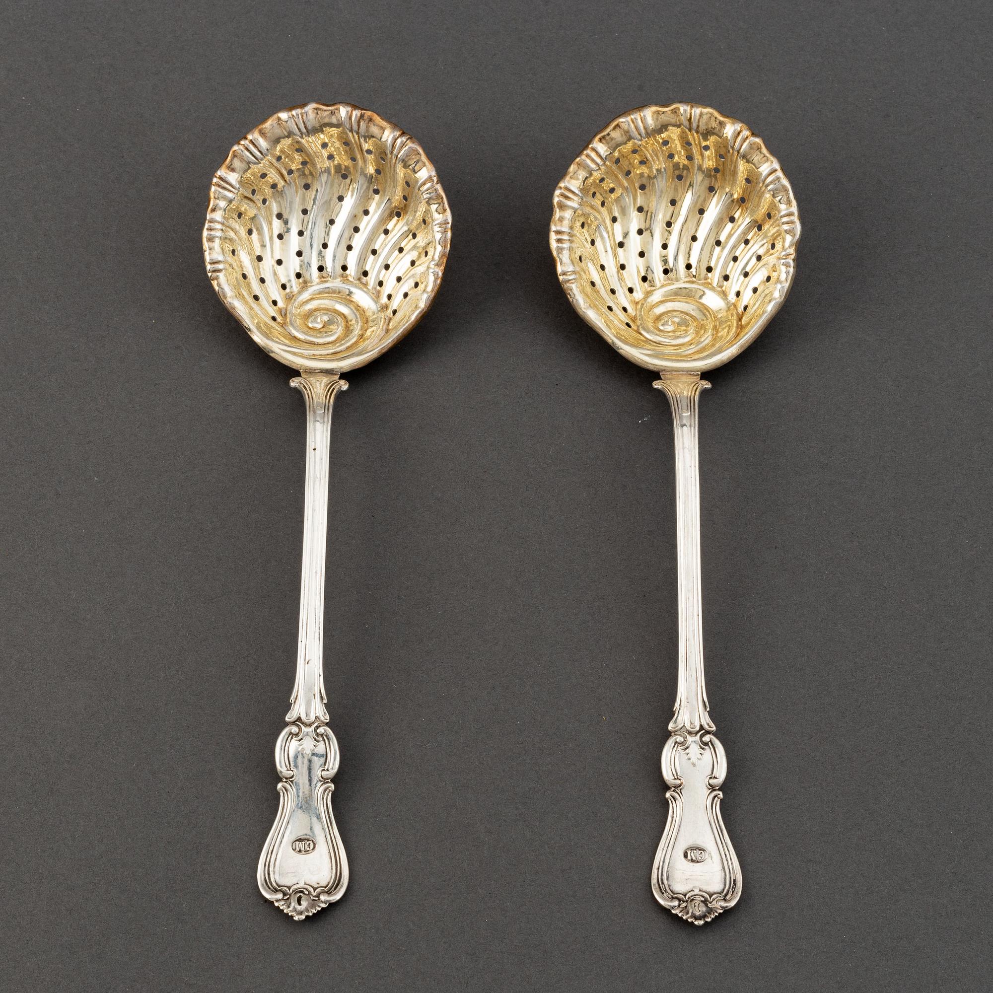 A pair of Swedish 19th century parcel-gilt silver caster-spoons, mark of PF Palmgren, Stockholm 1864.