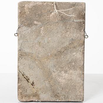 A Qajar moulded figural pottery tile, ca 26 x 19 cm.