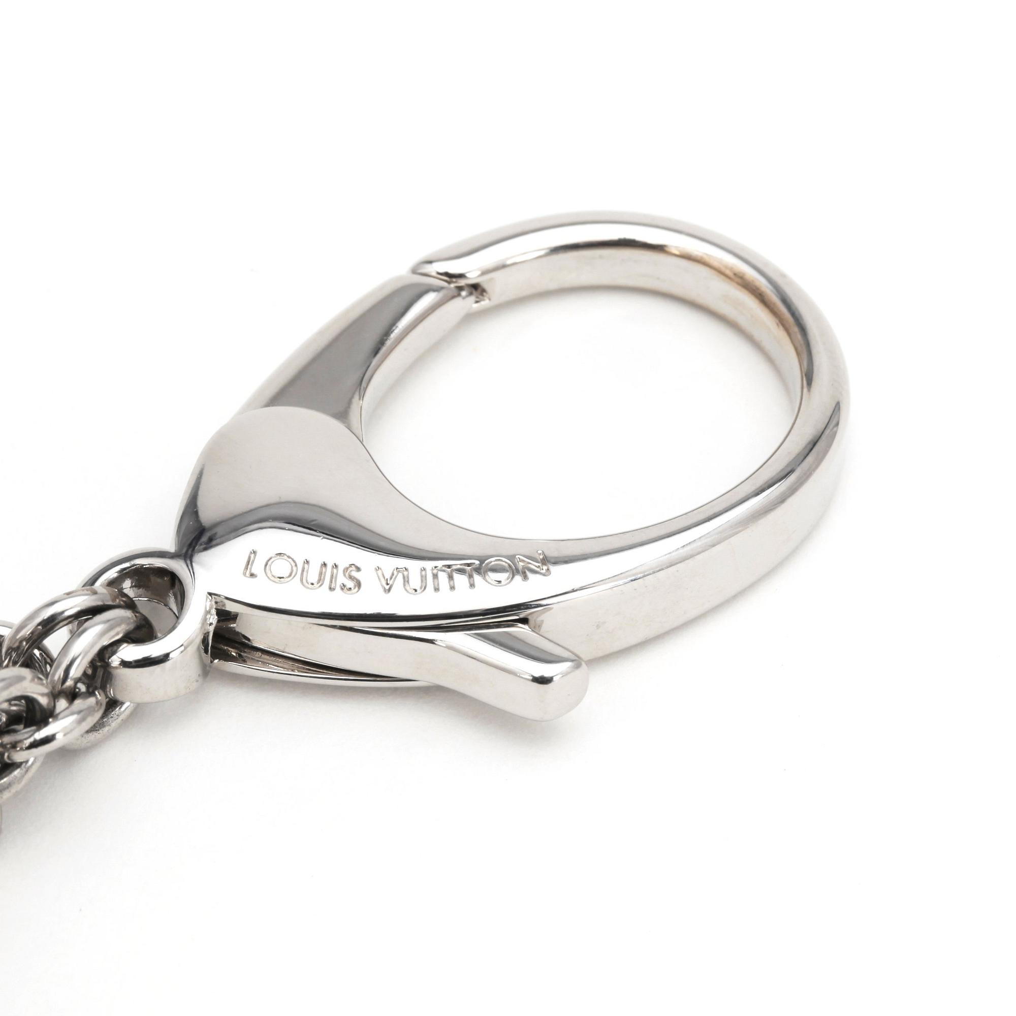 LOUIS VUITTON, a palladium finished brass and white bag charm, "Fleur d'epi".