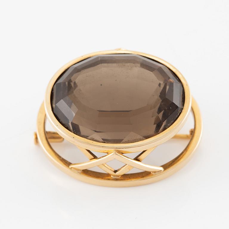 Brosch 18K guld med en fasettslipad rökkvarts.