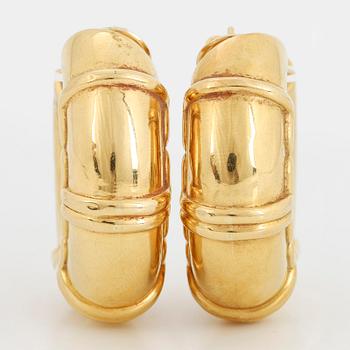 A pair of 18K gold earrings.